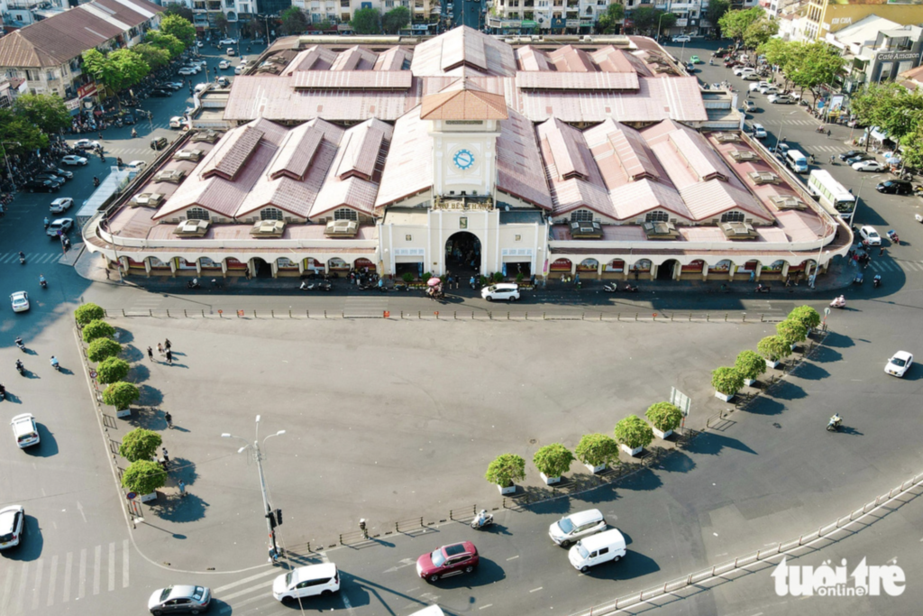 The iconic Ben Thanh Market in Ho Chi Minh City, with its distinctive clock tower and bustling entrance.
